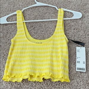 Out from under yellow crop top